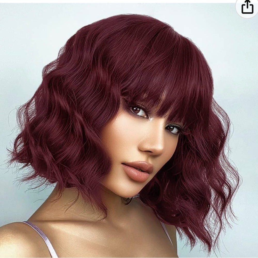 Brand new, in package, wine red short wavy wig with bangs. Comes with wig caps